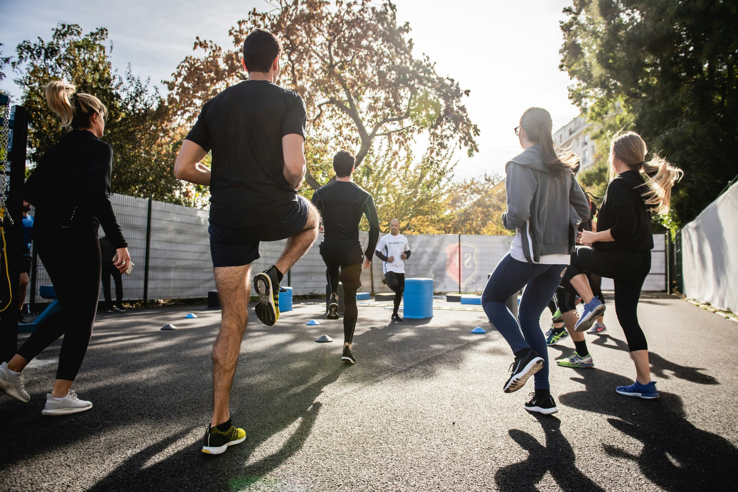 man in black t-shirt and black shorts running on road during daytime